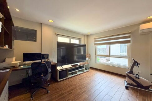 Work area and TV lounge inside the master suite of a 3-storey house near Country Mall
