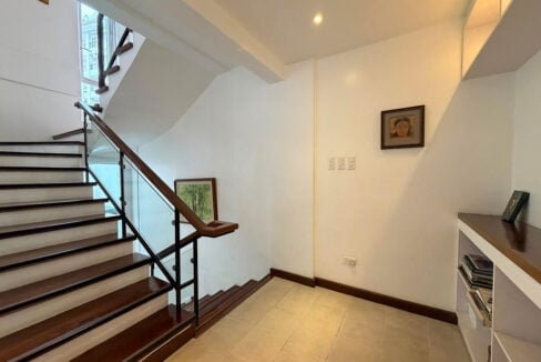 Staircase with wood treads and glass-and-metal railings