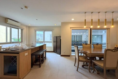 Kitchen island with breakfast stools beside the dining area in this Banilad house