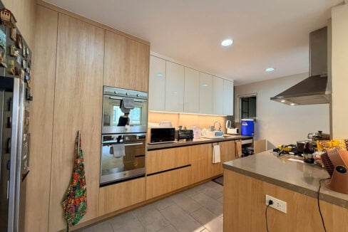 Wood-grain cabinetry with double built-in ovens