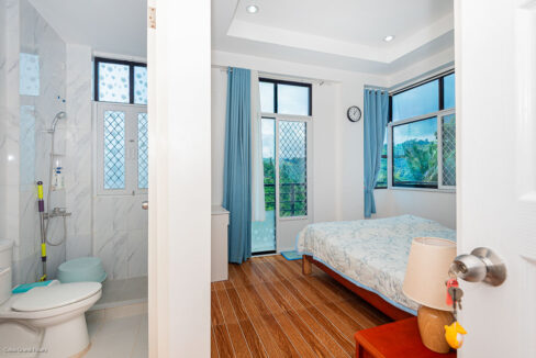 Bedroom with a double bed and an en-suite bathroom with hand shower