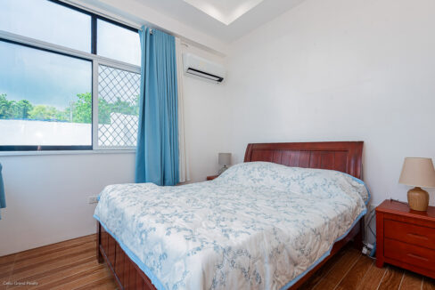Double bed with a wooden headboard and matching bedside tables