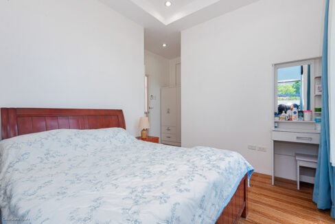 Bedroom with a white wardrobe and a dressing table with mirror