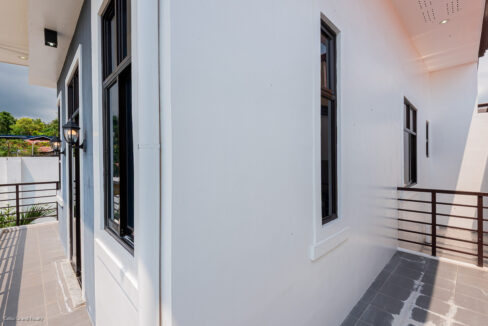 Upper-floor terrace wrapping around the corner of the house