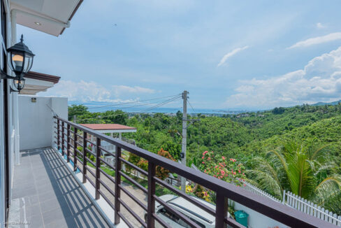 Balcony with a wall lantern looking out to the sea and the Minglanilla hills
