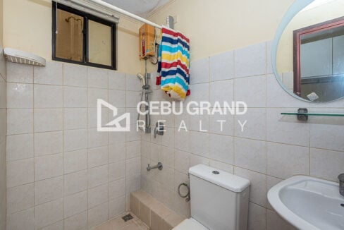 Bathroom with shower, electric water heater, toilet and pedestal sink
