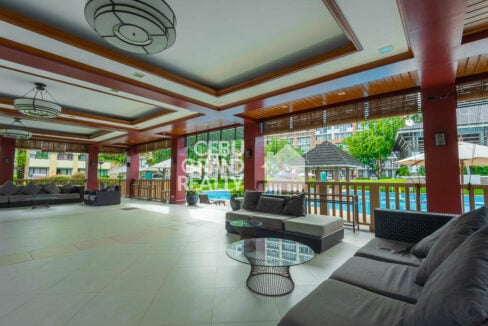 Clubhouse lounge with sofas overlooking the One Oasis pools