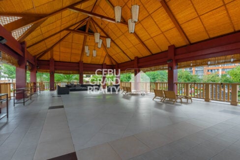 Open-air function pavilion with a high woven ceiling and lanterns