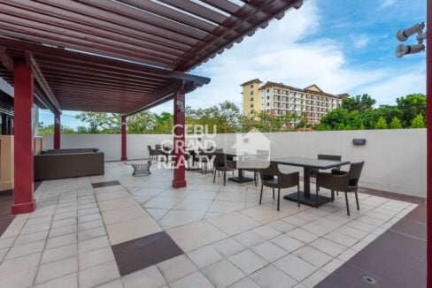 Terrace with outdoor dining sets and a view of the One Oasis buildings