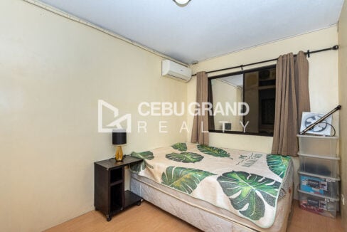 Bedroom with double bed, nightstand lamp and split-type air conditioner