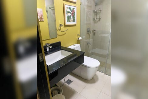 Bathroom with black granite vanity and glass-enclosed shower