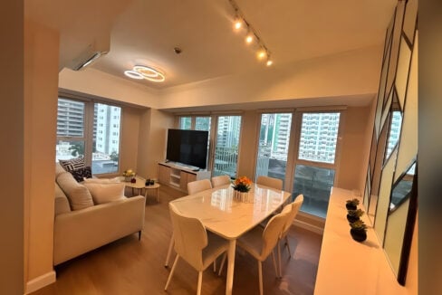 Living and dining area with windows on two sides and city views at Solinea, Cebu Business Park