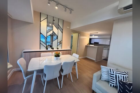 Dining table for six in front of the geometric mirrored feature wall and sideboard