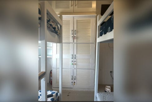 Bank of six lockable lockers with louvered doors