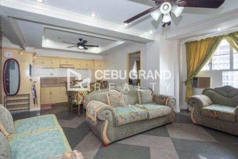 Living and dining area with tray ceilings and checkered tile floors in a Trinity Plaza 2BR condo