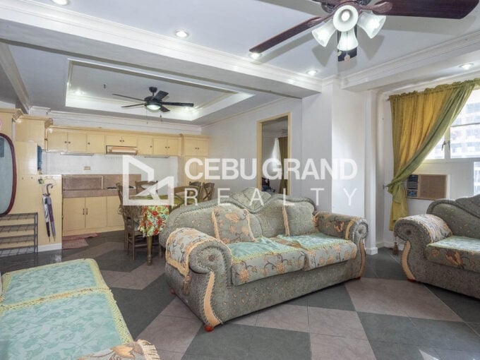 Living and dining area with tray ceilings and checkered tile floors in a Trinity Plaza 2BR condo