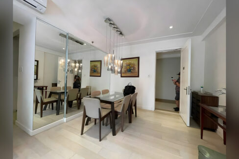 Dining area with a full mirrored wall and pendant lights
